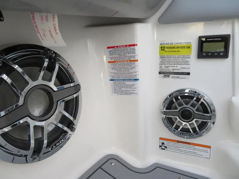 Slide: The Image of 2024 Chaparral 21 Surf boat interior with speakers and capacity labels. - 11