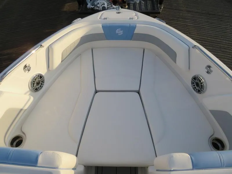 Slide: The Image of 2024 Chaparral 21 Surf boat interior with cushioned seating and built-in speakers. - 13