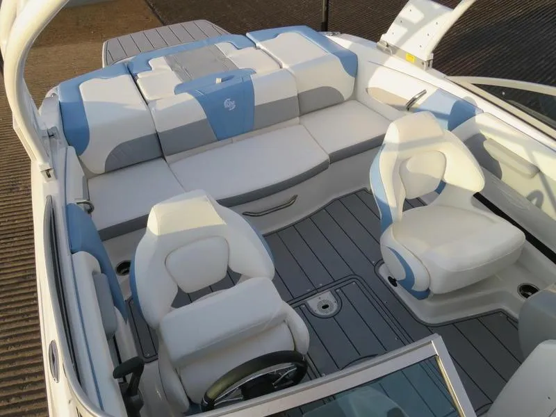 Slide: The Image of 2024 Chaparral 21 Surf boat interior with white and blue seating. - 15