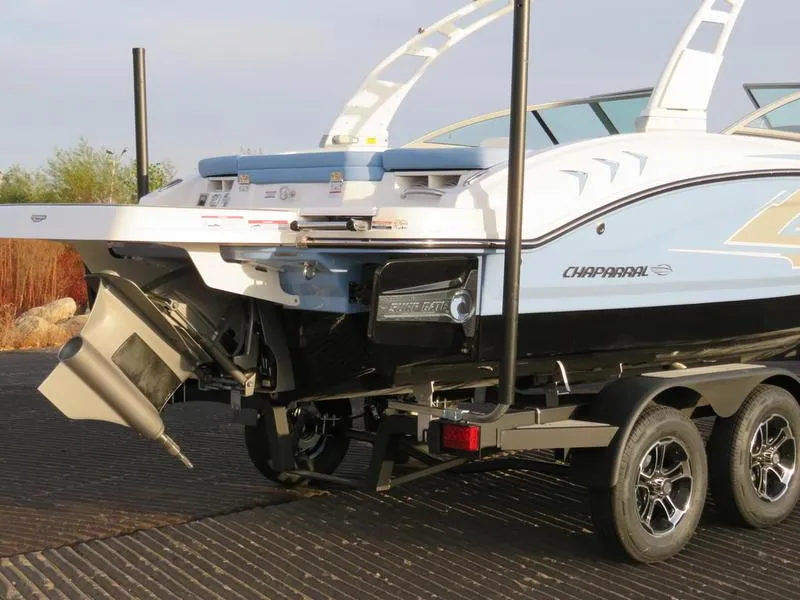 Slide: The Image of 2024 Chaparral 21 Surf boat on trailer, rear view. - 2