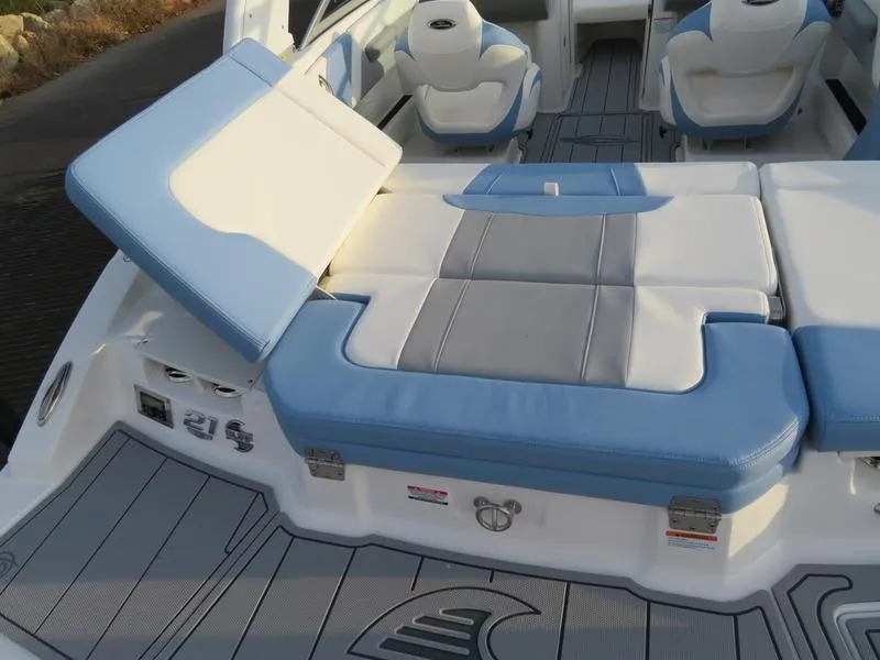 Slide: The Image of 2024 Chaparral 21 Surf boat interior with blue and white seating. - 6