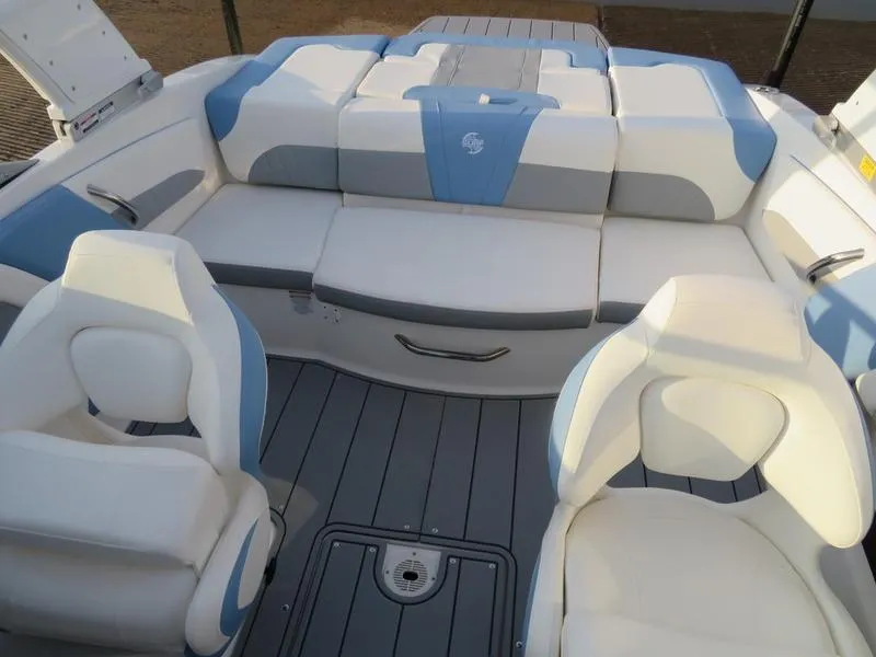 Slide: The Image of 2024 Chaparral 21 Surf boat interior with white and blue seating. - 8