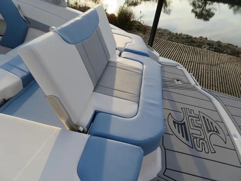 Slide: The Image of 2024 Chaparral 21 Surf boat interior with blue and white seating. - 9