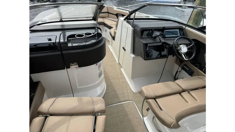 Slide: The Image of 2016 Sea Ray 280 SLX boat interior with beige seating and sleek dashboard. - 3