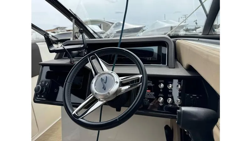 Slide: The Image of 2016 Sea Ray 280 SLX boat dashboard with steering wheel and control panel. - 5