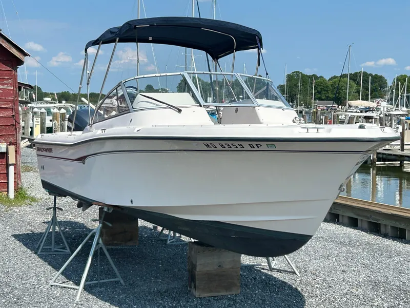 Slide: The Image of 2003 Grady-White Tournament 225 boat on stands at marina. - 0