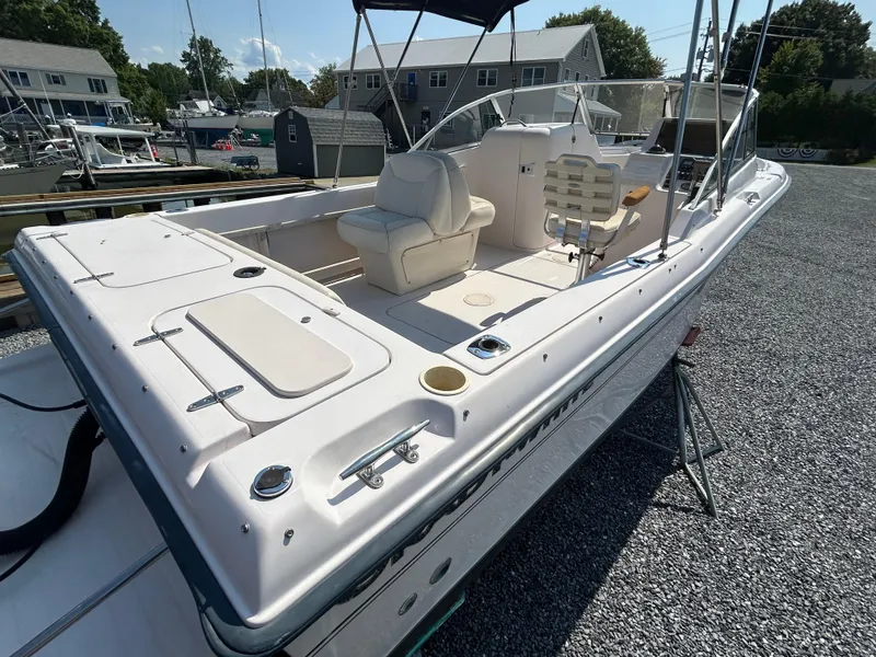 Slide: The Image of 2003 Grady-White Tournament 225 boat with spacious deck and seating, docked in a marina. - 1