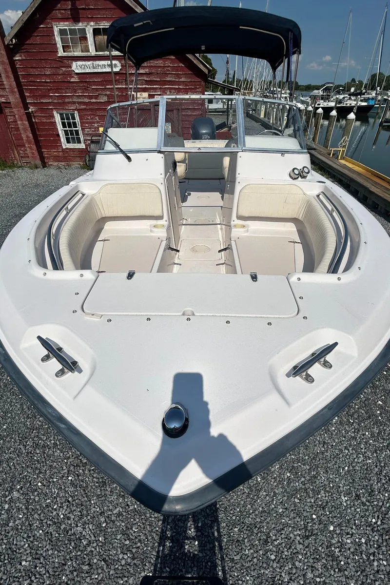 Slide: The Image of 2003 Grady-White Tournament 225 boat docked near a marina. - 2