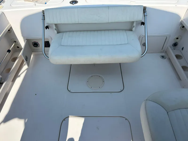 Slide: The Image of 2003 Grady-White Tournament 225 boat interior with white seating and clean deck. - 5
