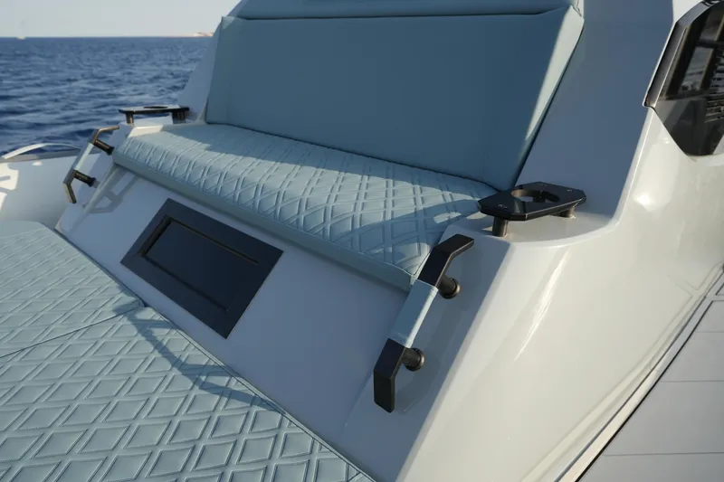 Slide: The Image of 2025 Ranieri Cayman 33 Executive boat with luxurious seating and ocean backdrop. - 12