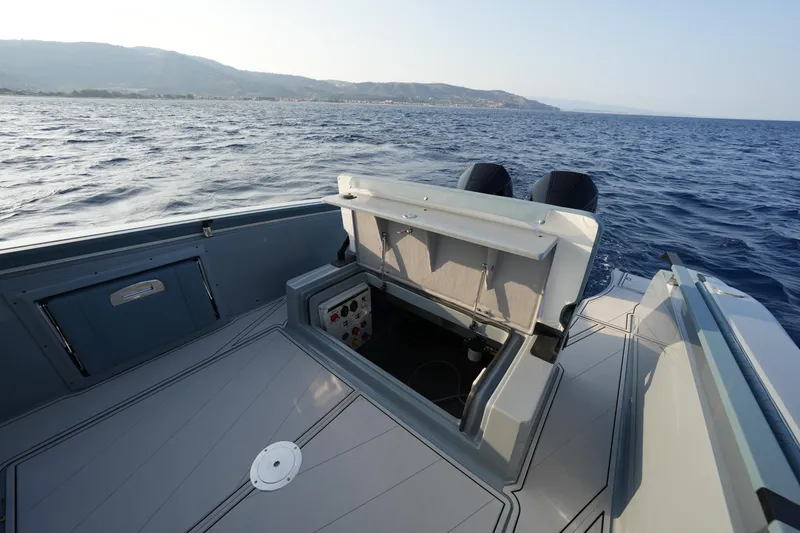 Slide: The Image of 2025 Ranieri Cayman 33 Executive boat interior with open storage compartment on the ocean. - 16