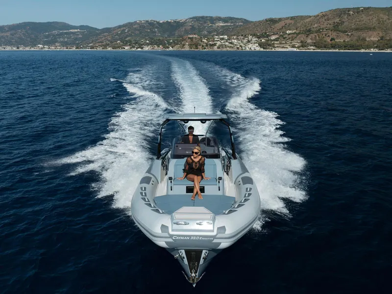 Slide: The Image of 2025 Ranieri Cayman 33 Executive cruising on open water with passengers. - 8