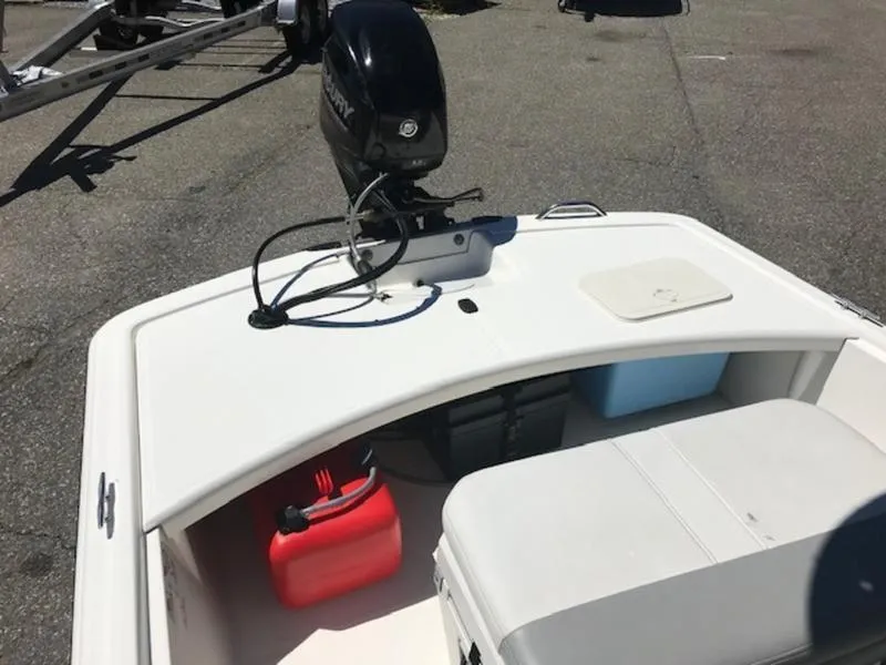 Slide: The Image of 2018 Mako 17 SKIFF CC boat with outboard motor and storage compartments. - 2