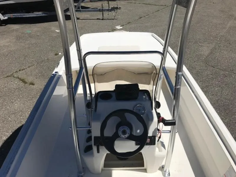 Slide: The Image of 2018 Mako 17 SKIFF CC center console boat with steering wheel and controls. - 4