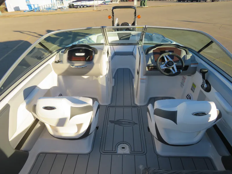 Slide: The Image of 2024 Chaparral 21 SSi boat interior with dual captain's chairs and modern dashboard. - 12