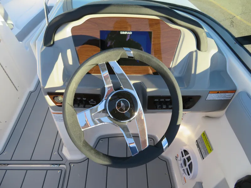 Slide: The Image of 2024 Chaparral 21 SSi boat steering wheel and dashboard. - 13