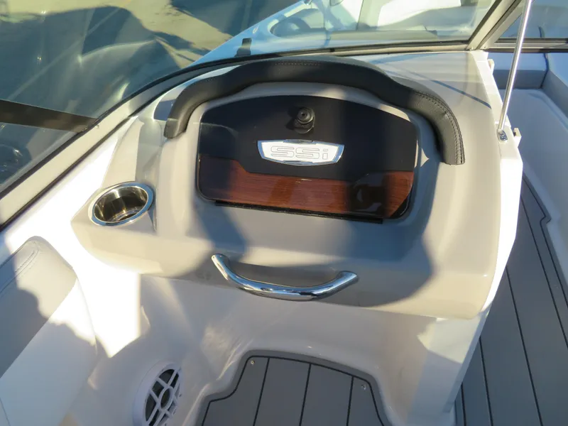 Slide: The Image of 2024 Chaparral 21 SSi boat dashboard with cup holder and storage compartment. - 14