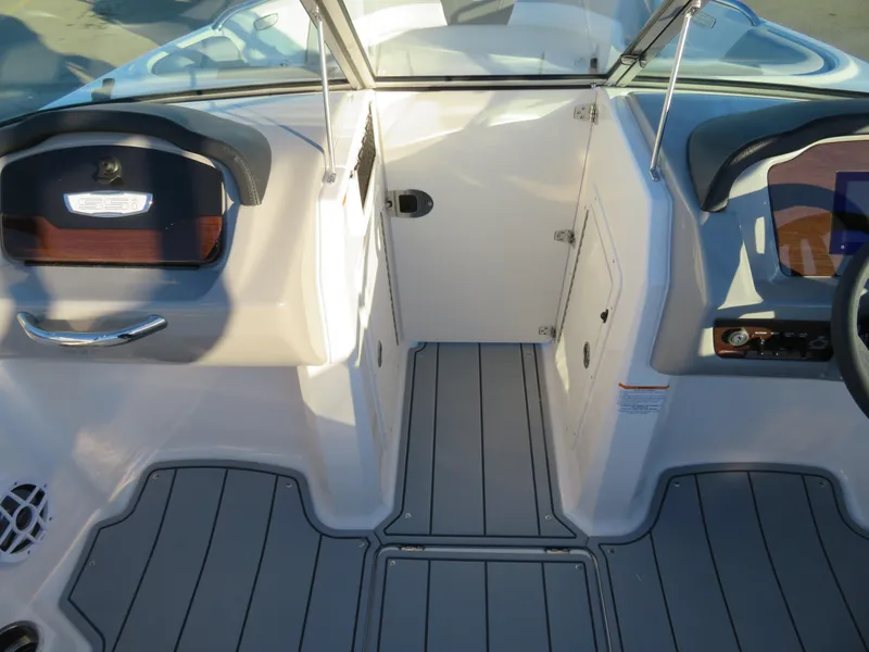 Slide: The Image of 2024 Chaparral 21 SSi boat interior with gray flooring and modern dashboard. - 15