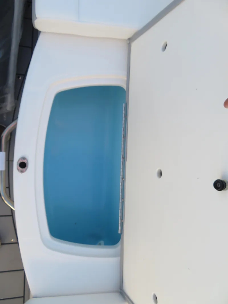 Slide: The Image of 2024 Chaparral 21 SSi boat interior with storage compartment. - 18