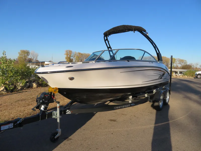 Slide: The Image of 2024 Chaparral 21 SSi boat on a trailer in a sunny outdoor setting. - 2