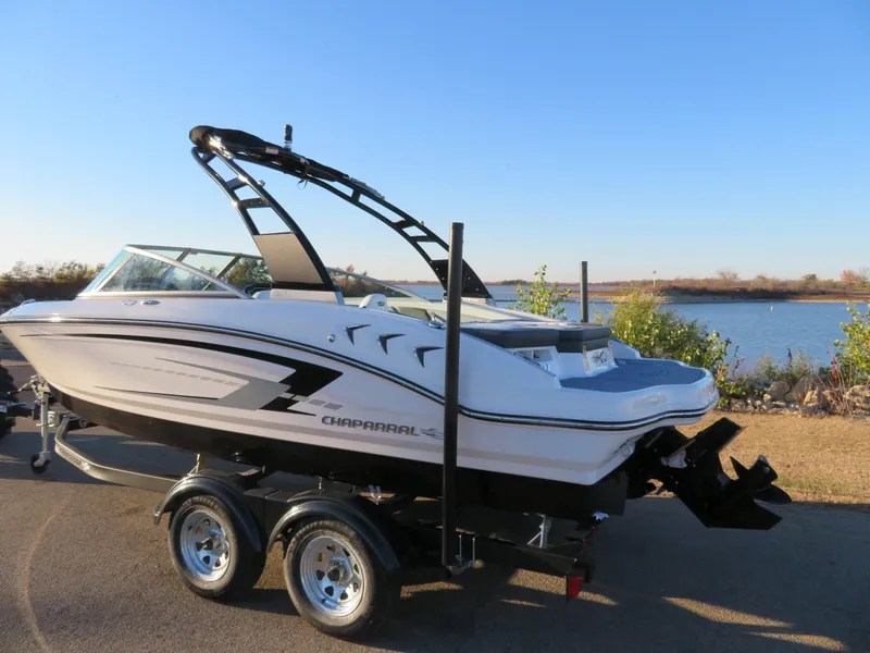 Slide: The Image of 2024 Chaparral 21 SSi boat on trailer by a lake. - 3