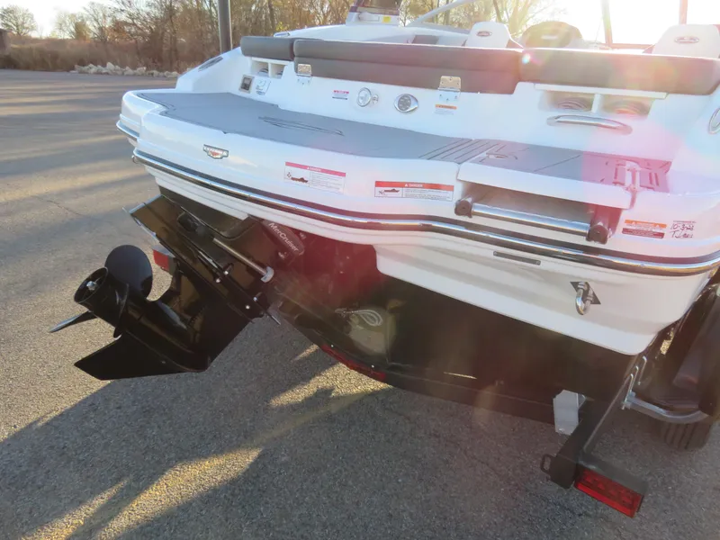 Slide: The Image of 2024 Chaparral 21 SSi boat rear view showing outboard motor and swim platform. - 8