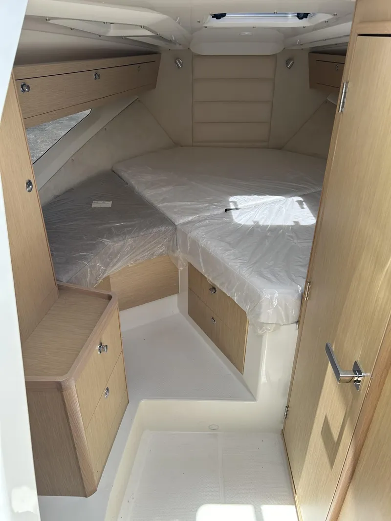 Slide: The Image of 2023 Skamander 850 Voyager interior cabin with wooden steps and skylight. - 16