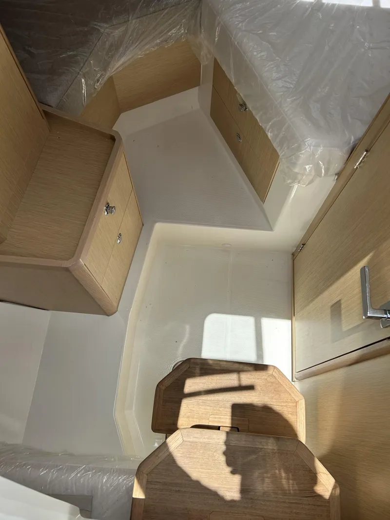 Slide: The Image of 2023 Skamander 850 Voyager boat interior with spacious seating and modern design. - 17