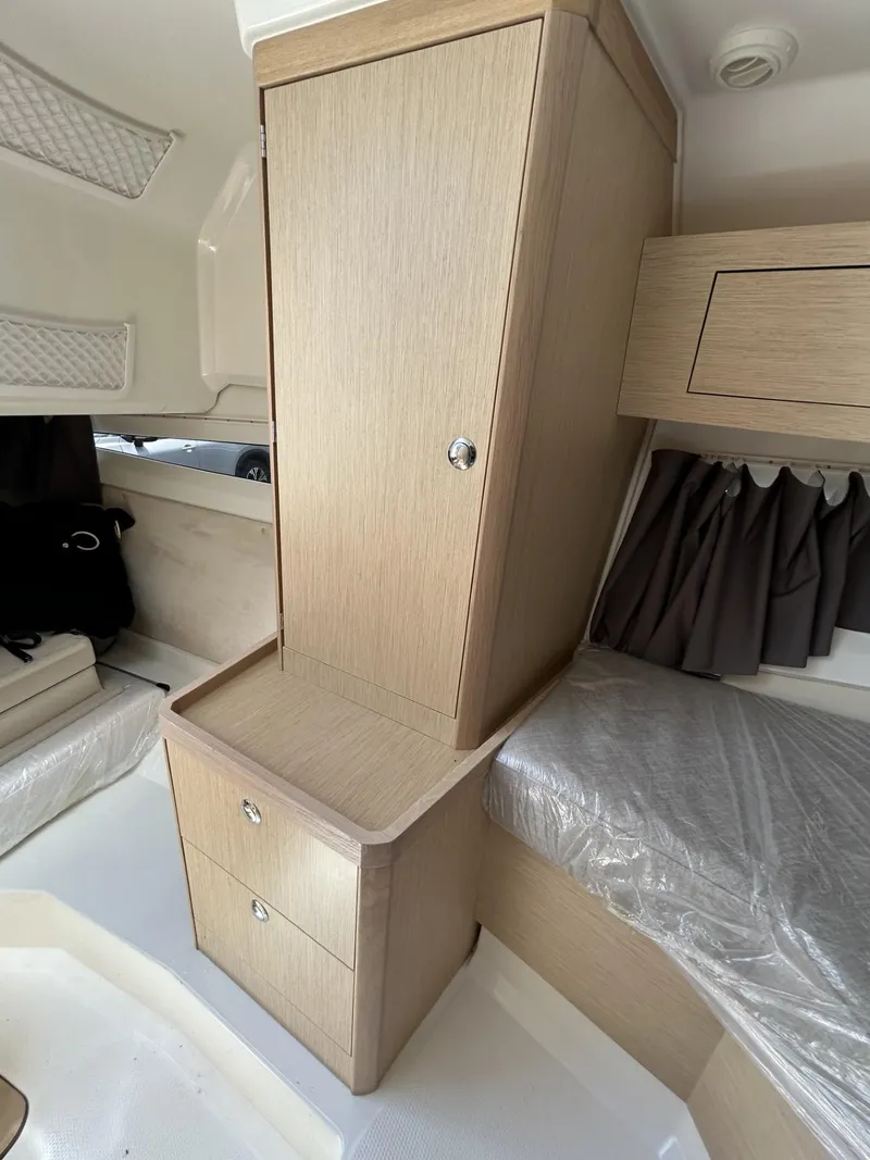 Slide: The Image of 2023 Skamander 850 Voyager boat on a trailer under a partly cloudy sky. - 20