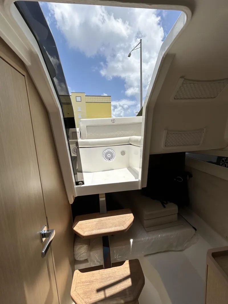 Slide: The Image of 2023 Skamander 850 Voyager boat on a Continental trailer under a blue sky. - 21