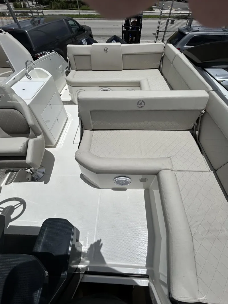 Slide: The Image of 2023 Skamander 850 Voyager boat on trailer under a sunny sky. - 22