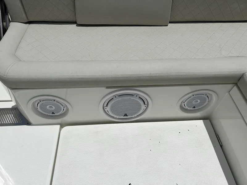 Slide: The Image of 2023 Skamander 850 Voyager boat on a trailer under a partly cloudy sky. - 24