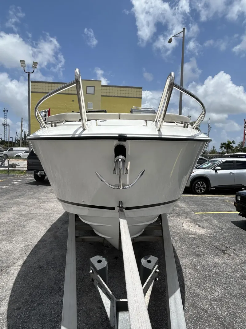 Slide: The Image of 2023 Skamander 850 Voyager boat on a trailer under a cloudy sky. - 27