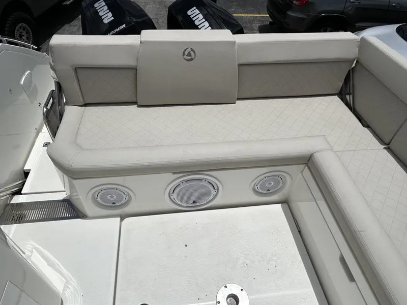 Slide: The Image of 2023 Skamander 850 Voyager boat interior with cushioned seating and built-in speakers. - 8