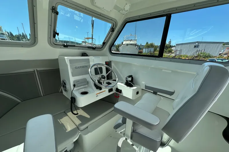 Slide: The Image of Interior of 2025 Parker 2420 Sport Cabin boat with Garmin navigation system. - 18