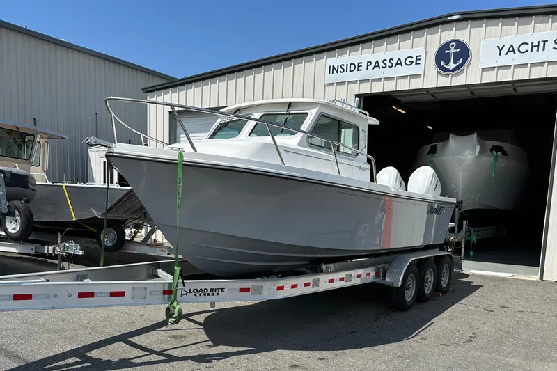 Slide: The Image of 2025 Parker 2420 Sport Cabin boat on trailer outside Inside Passage Yacht Sales. - 5