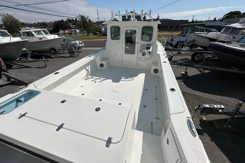 Slide: The Image of 2025 Parker 2420 Sport Cabin boat with spacious deck and modern design. - 9