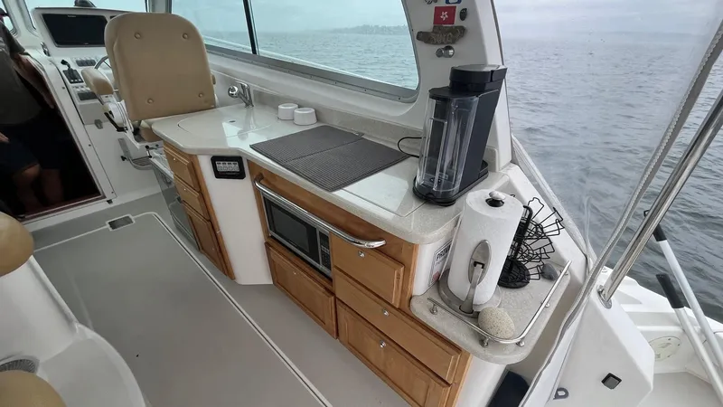 Slide: The Image of Interior of 2014 Back Cove 34 boat with kitchenette and ocean view. - 12
