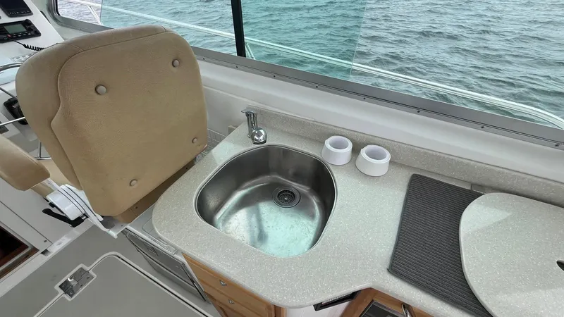 Slide: The Image of Interior of 2014 Back Cove 34 boat with sink and seating by the window. - 14