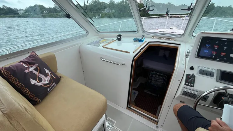 Slide: The Image of Interior of 2014 Back Cove 34 boat with helm and cabin entrance. - 16