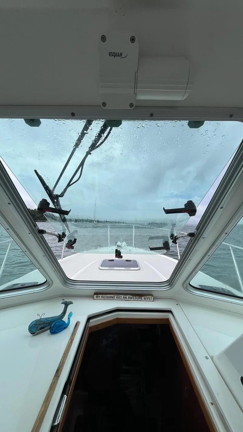 Slide: The Image of 2014 Back Cove 34 boat interior view through windshield on a cloudy day. - 20