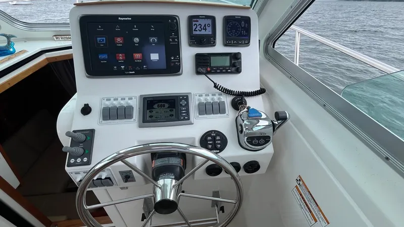 Slide: The Image of 2014 Back Cove 34 helm with navigation controls and steering wheel. - 21