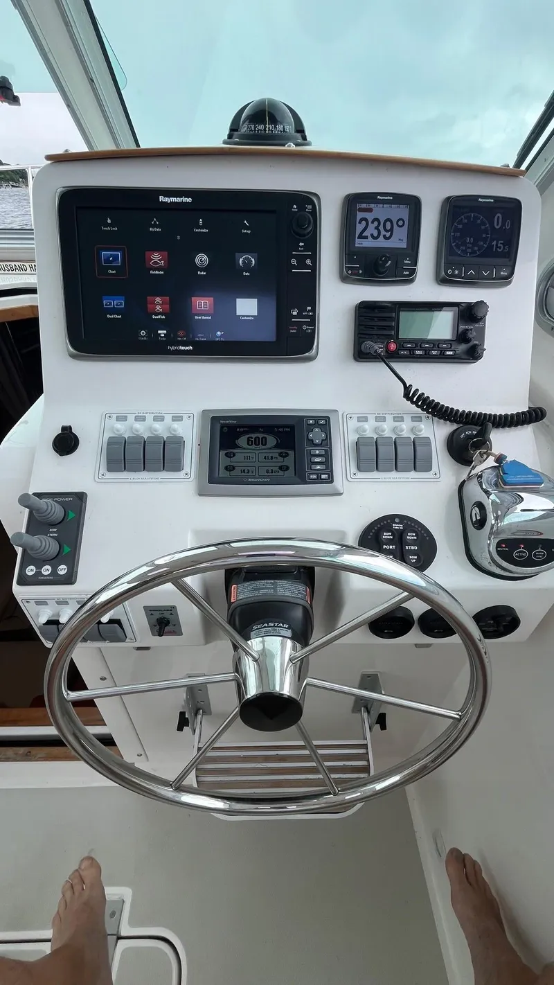 Slide: The Image of 2014 Back Cove 34 helm with navigation controls and steering wheel. - 22