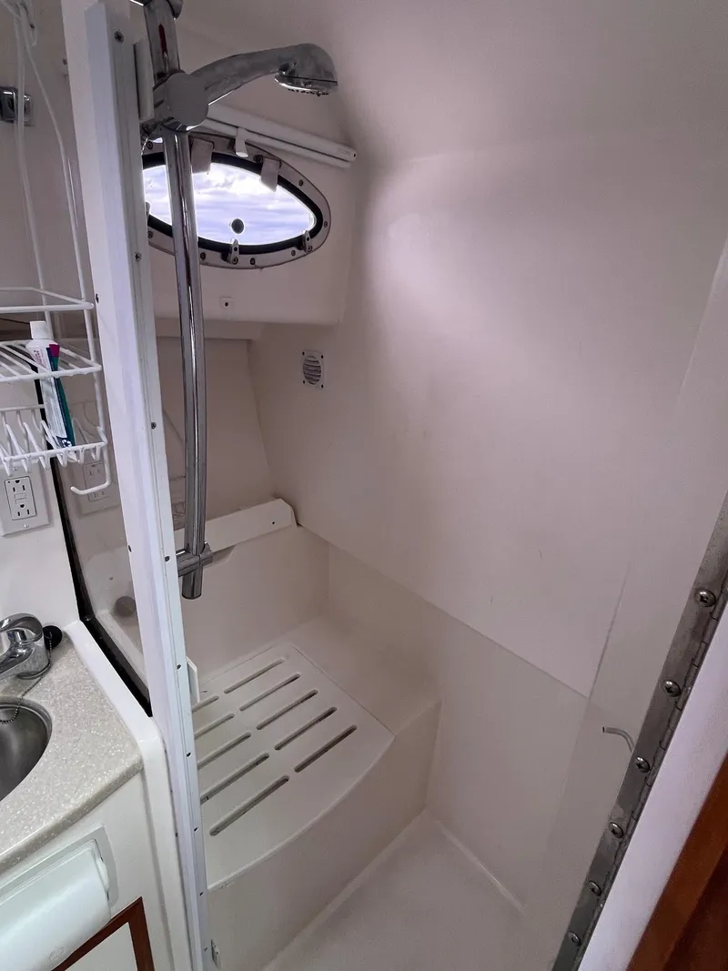 Slide: The Image of 2014 Back Cove 34 yacht bathroom with shower and sink. - 31