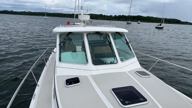 Slide: The Image of 2014 Back Cove 34 boat on calm water with overcast sky. - 4