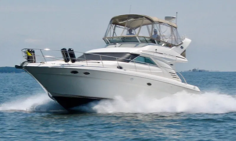 Slide: The Image of 2003 Sea Ray 400 Sedan Bridge yacht cruising on open water. - 0