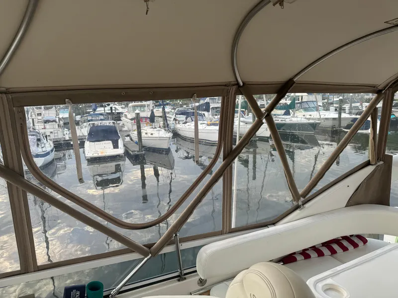 Slide: The Image of View from 2003 Sea Ray 400 Sedan Bridge, overlooking marina with docked boats. - 13