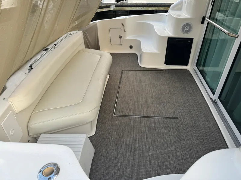 Slide: The Image of 2003 Sea Ray 400 Sedan Bridge interior with seating and carpeted floor. - 14