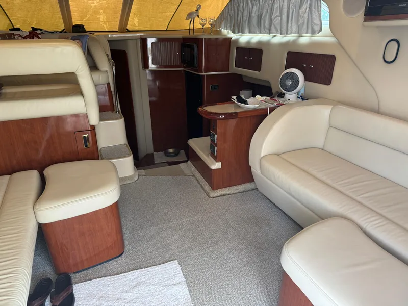 Slide: The Image of Interior of 2003 Sea Ray 400 Sedan Bridge with beige leather seating and wood accents. - 16