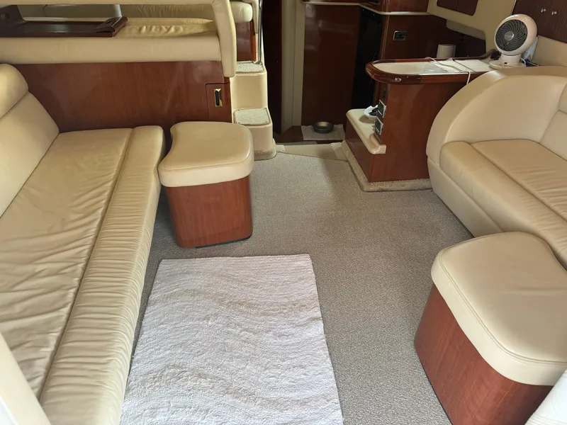 Slide: The Image of Interior of 2003 Sea Ray 400 Sedan Bridge with beige seating and wooden accents. - 18